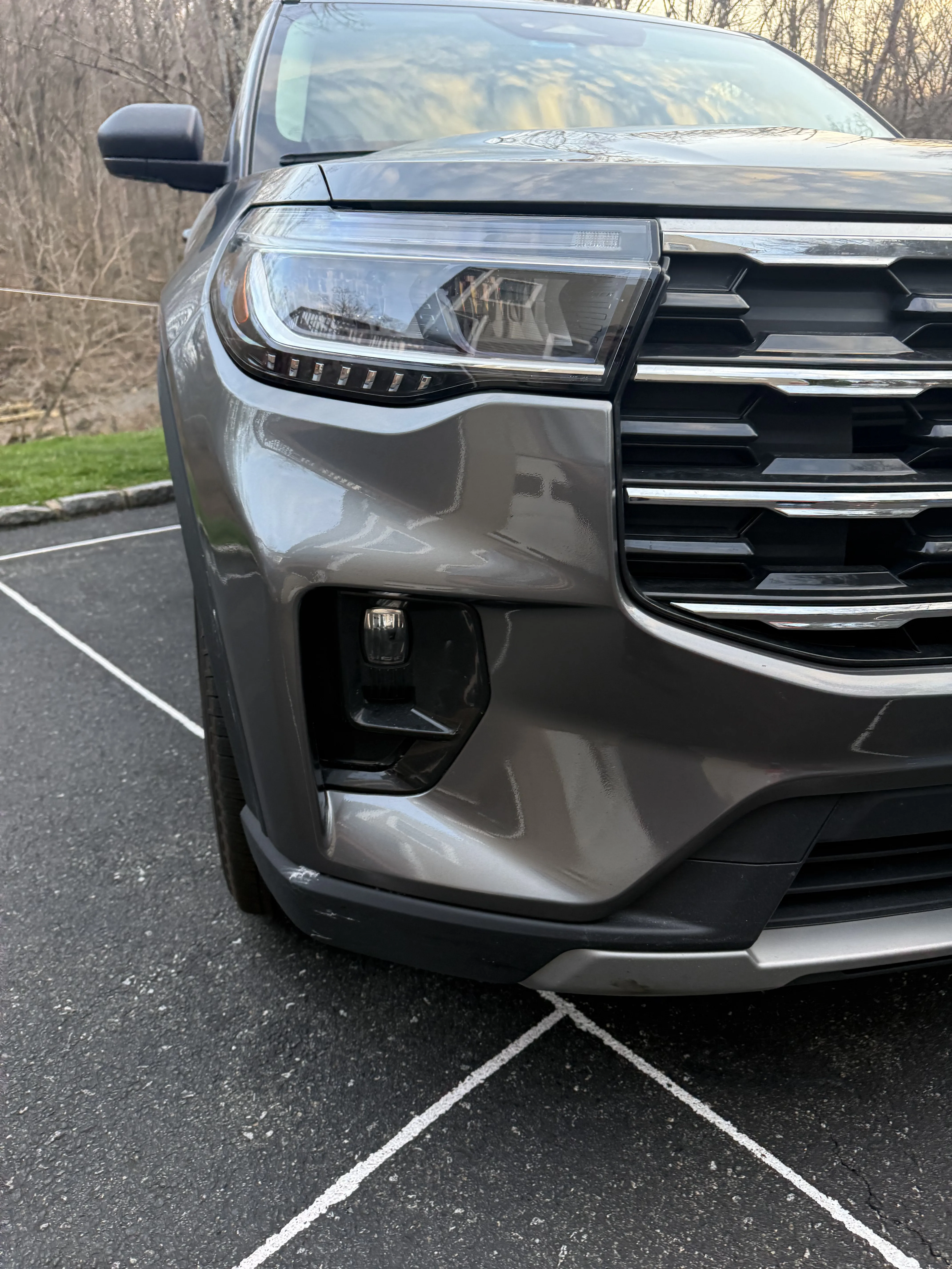 Same Ford Explorer front bumper after repair, smooth and color-matched.