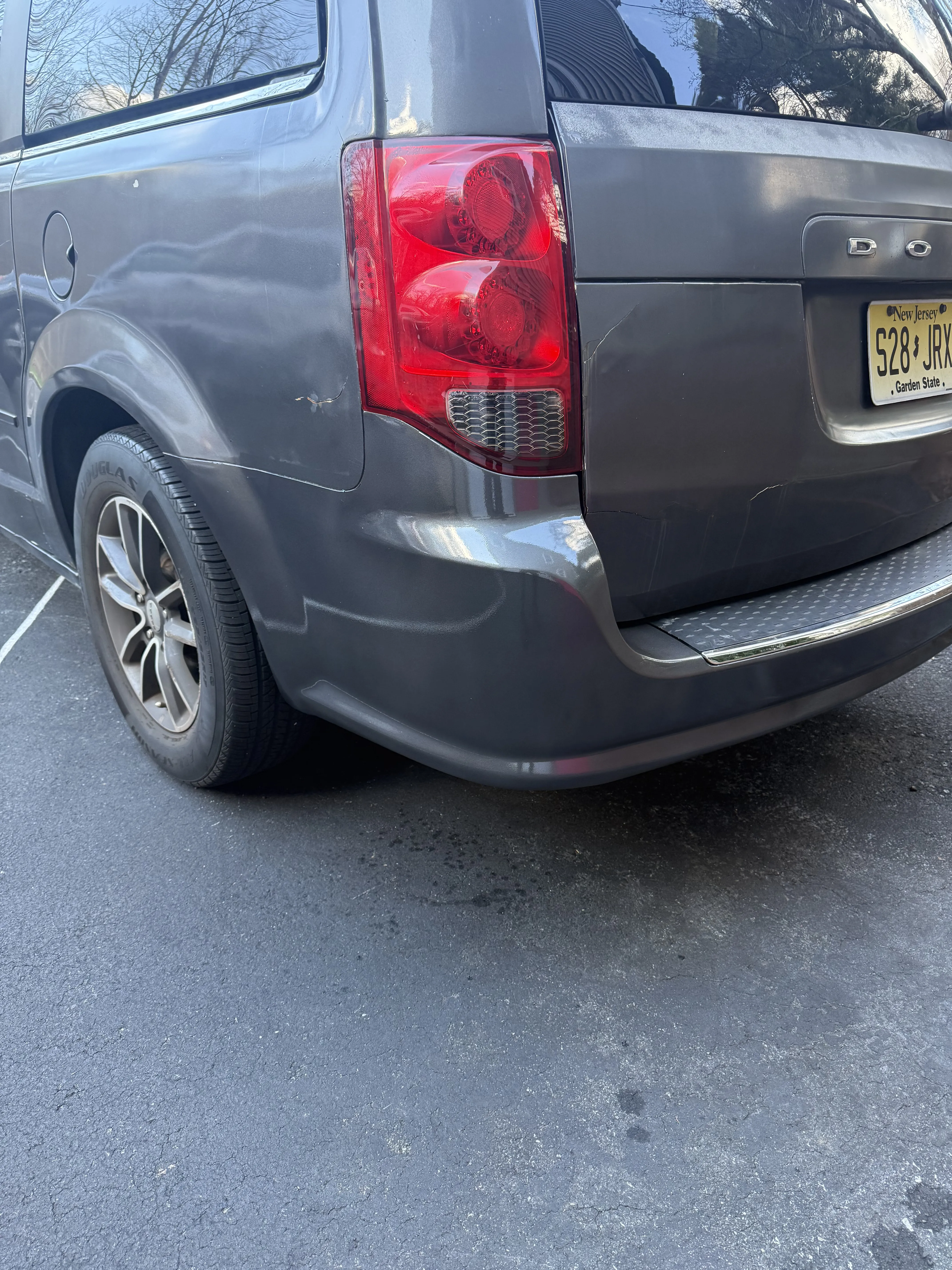 Same Dodge Grand Caravan rear bumper reinstalled and refinished, clean and straight.