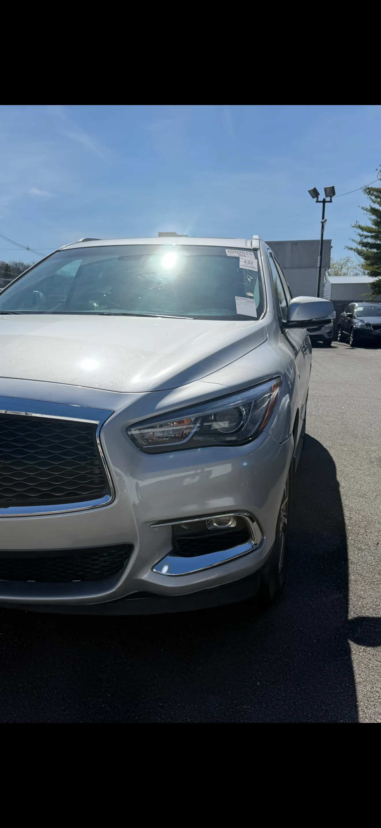 Silver Infiniti QX60 front bumper after repair, clean and smooth.